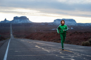 Creative commercial image of runner in Monument Valley mimicking the scene in Forrest Gump
